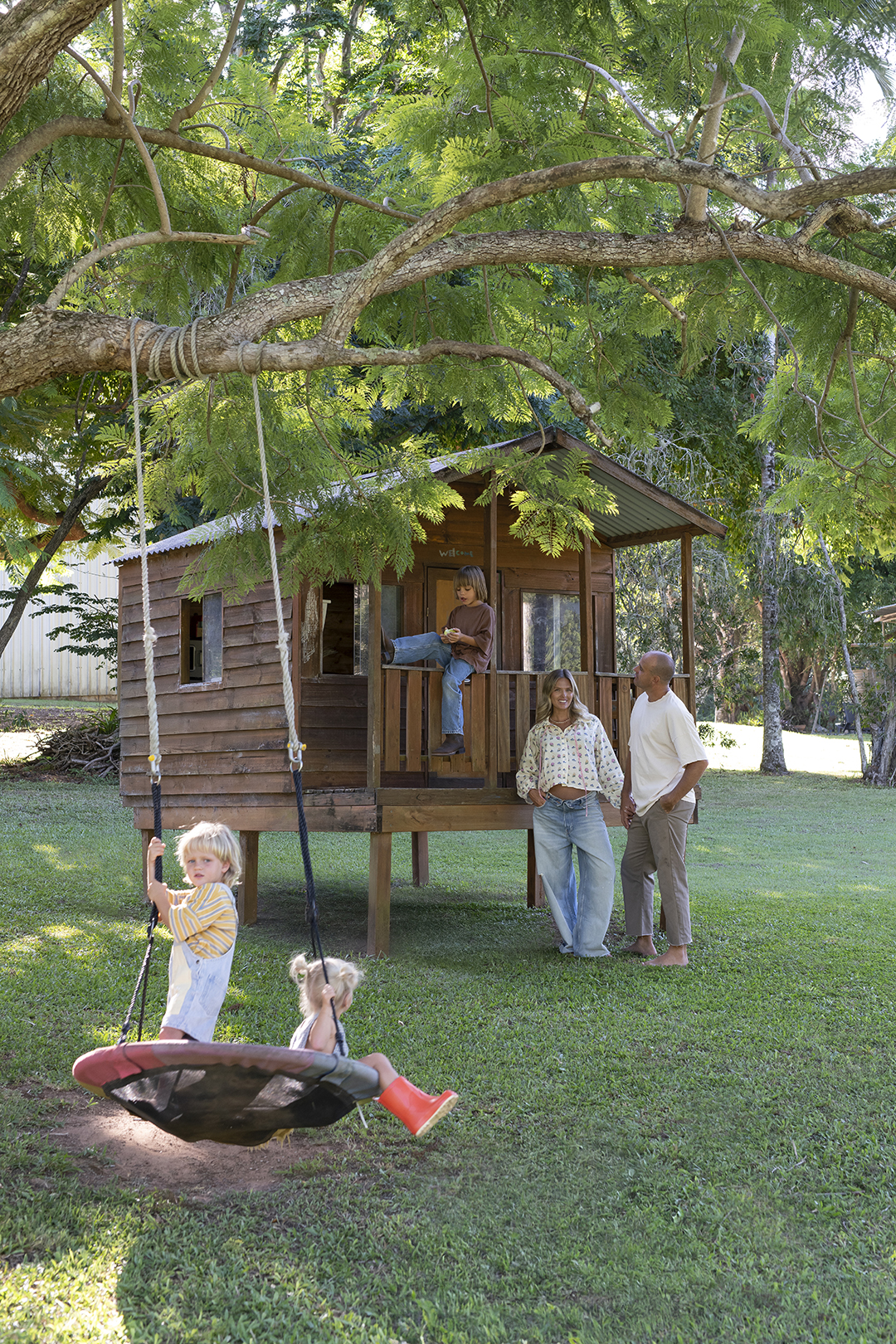 family outside kids fort and tire swing