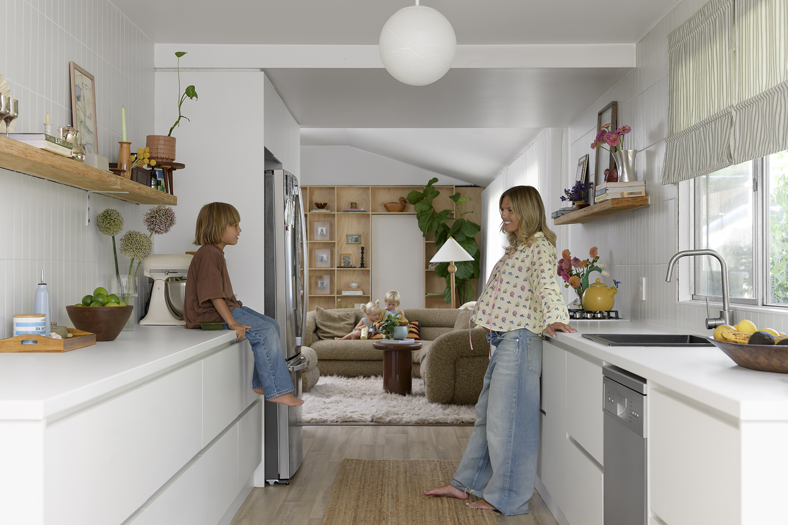 woman and boy in a white galley kitchen