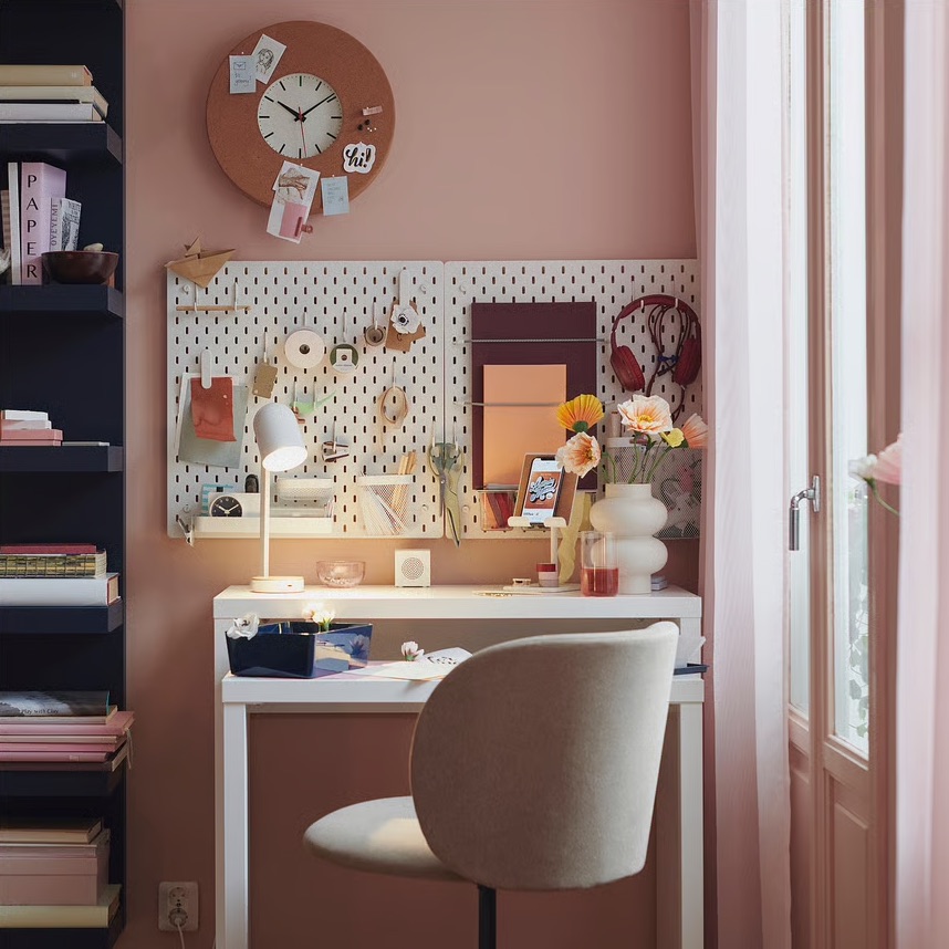 pull-out desk by IKEA in with pegboard above