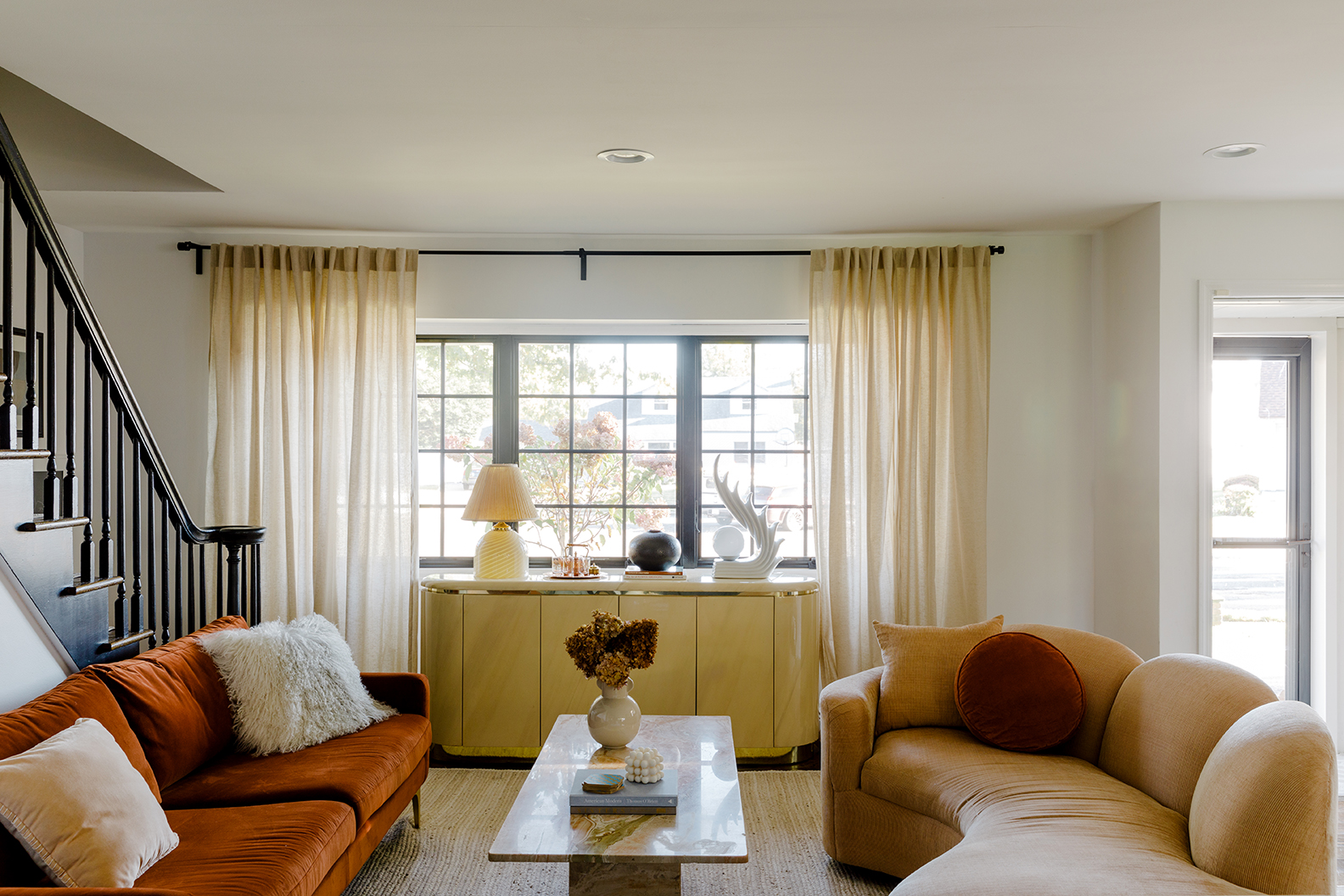 living room with two sofas and staircase