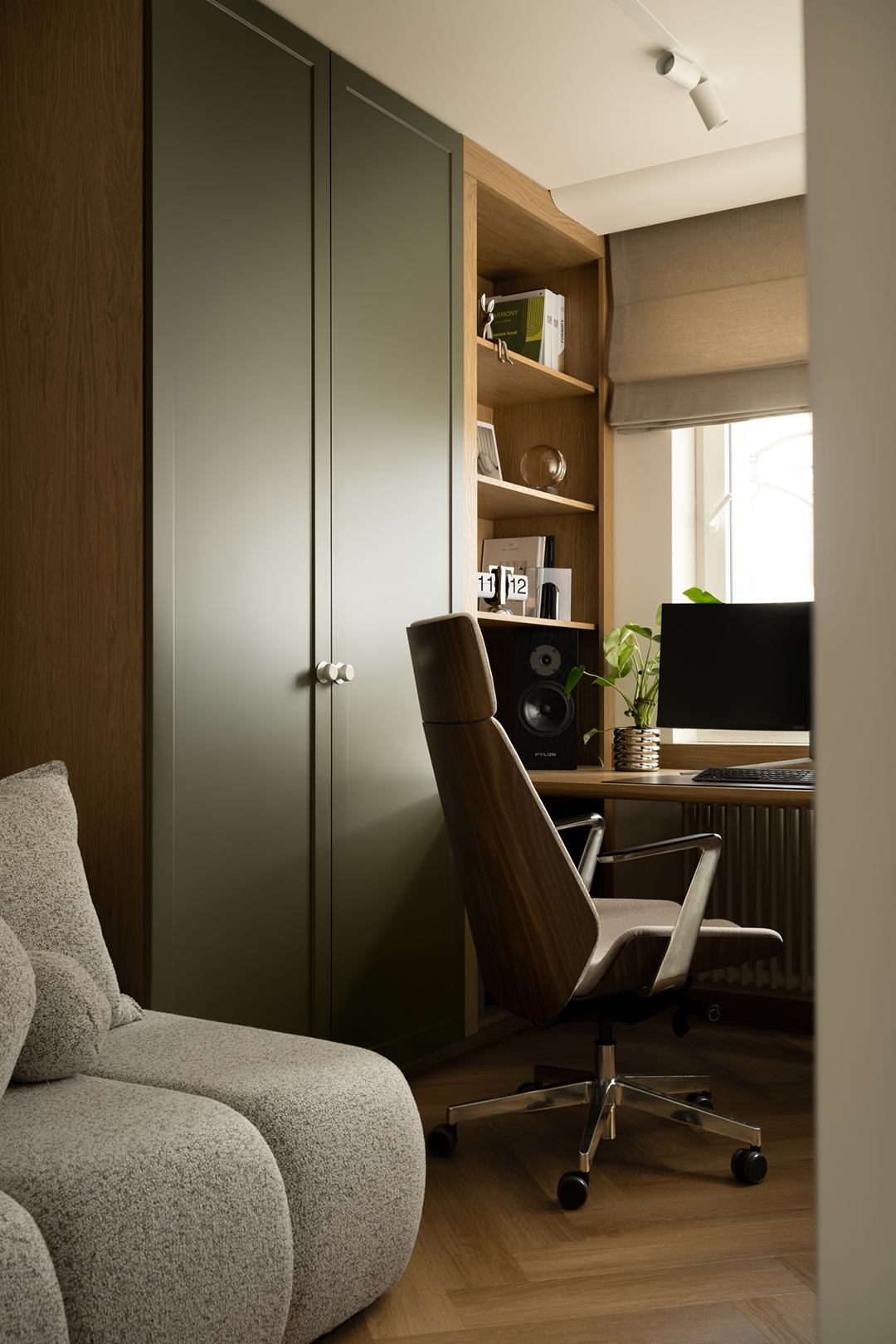 office with chair, monitor, and green doors for storage