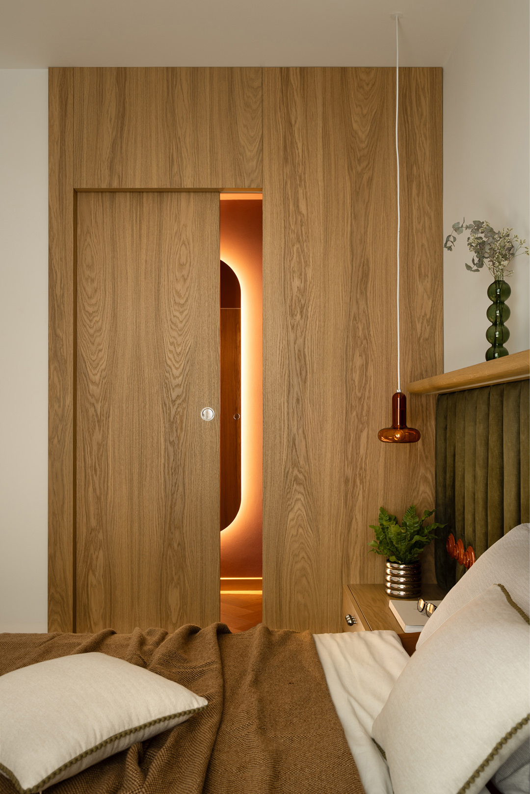 view in bedroom of slightly open door to bathroom