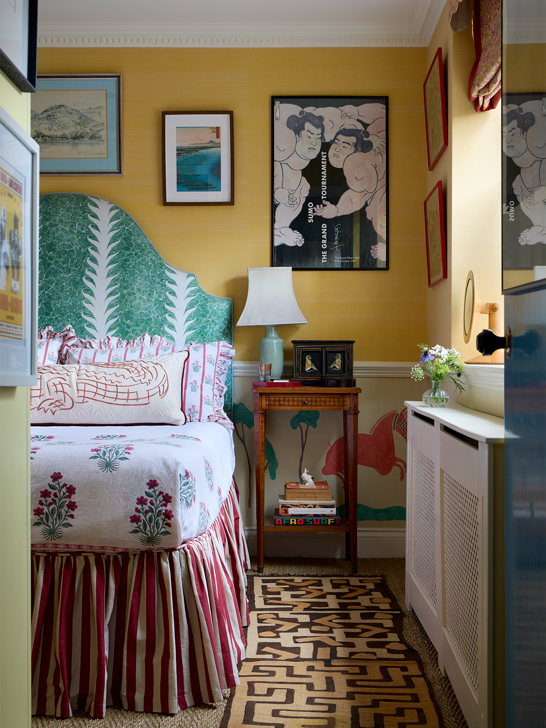 green upholstered bed in a yellow room