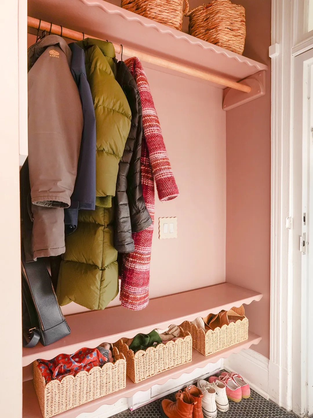 hanging rod for coats in pink mudroom