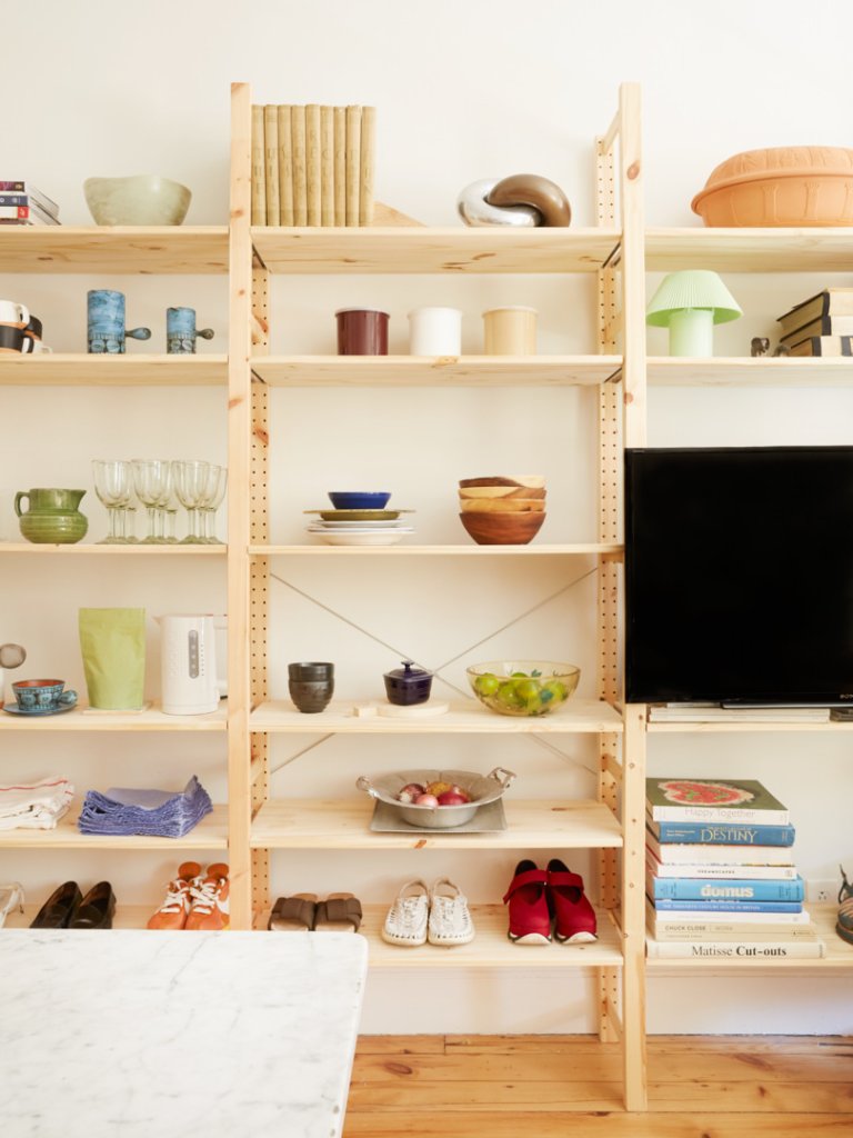 wood shelving unit with objects and shoes