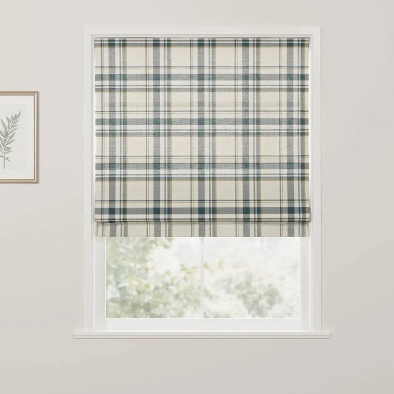 Window with blue plaid Roman shade.