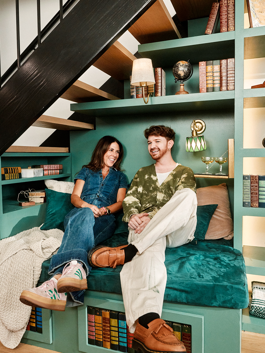woman and man sitting in nook under the stairs