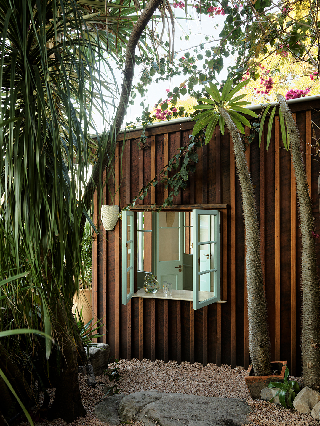 wood-sided structure with large open window