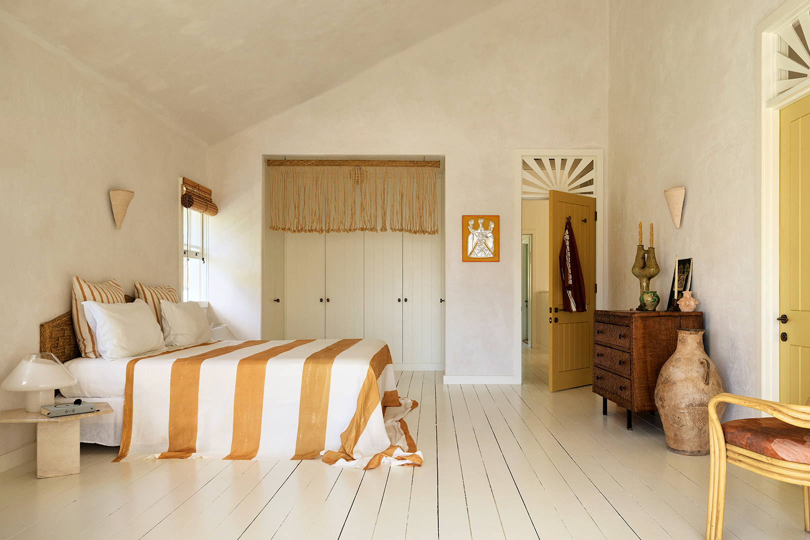 bedroom with striped bed and recessed closet