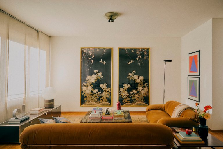 living room with tan sofas and artwork on walls