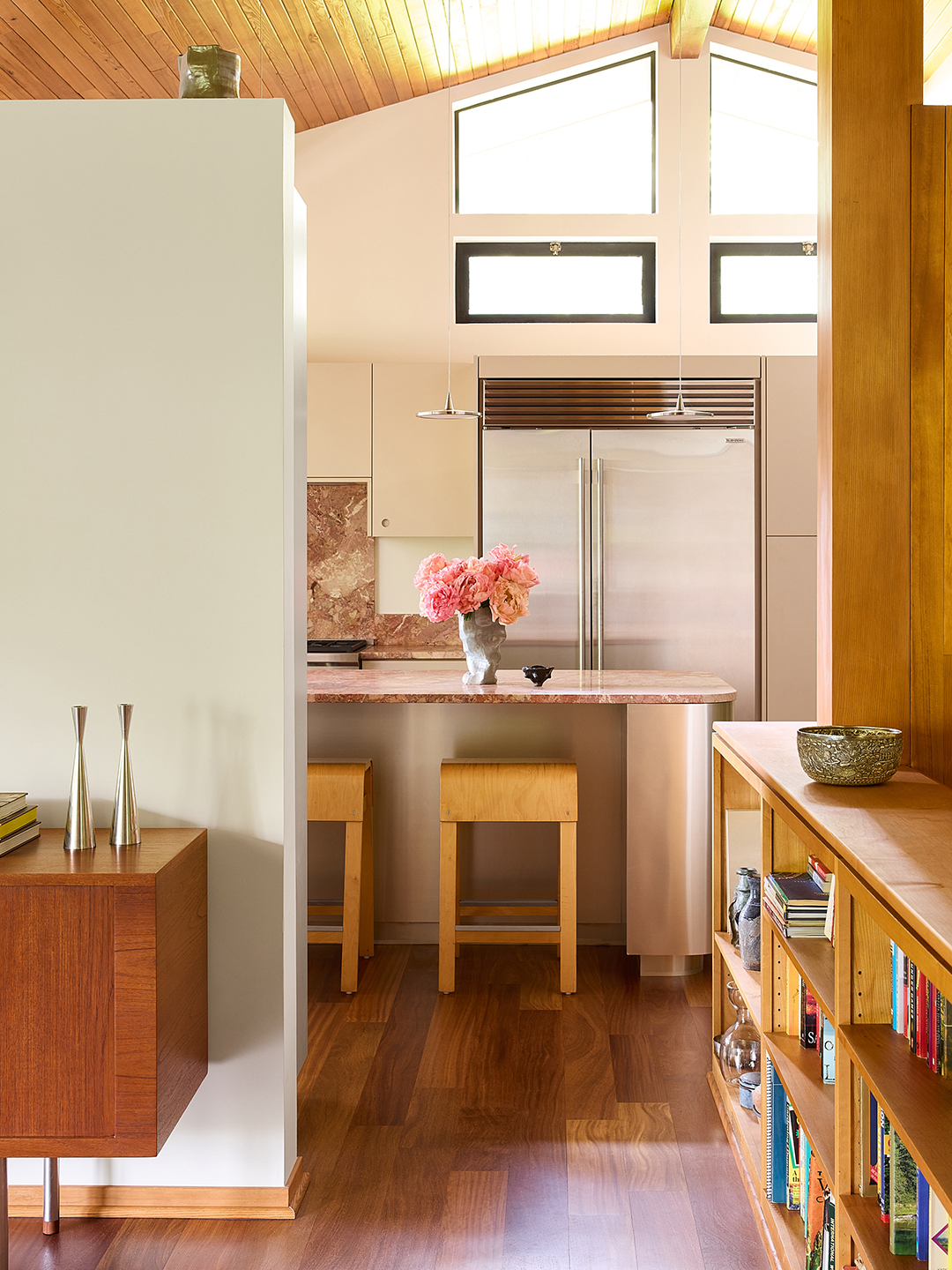 view into kitchen with wood accents and metal island