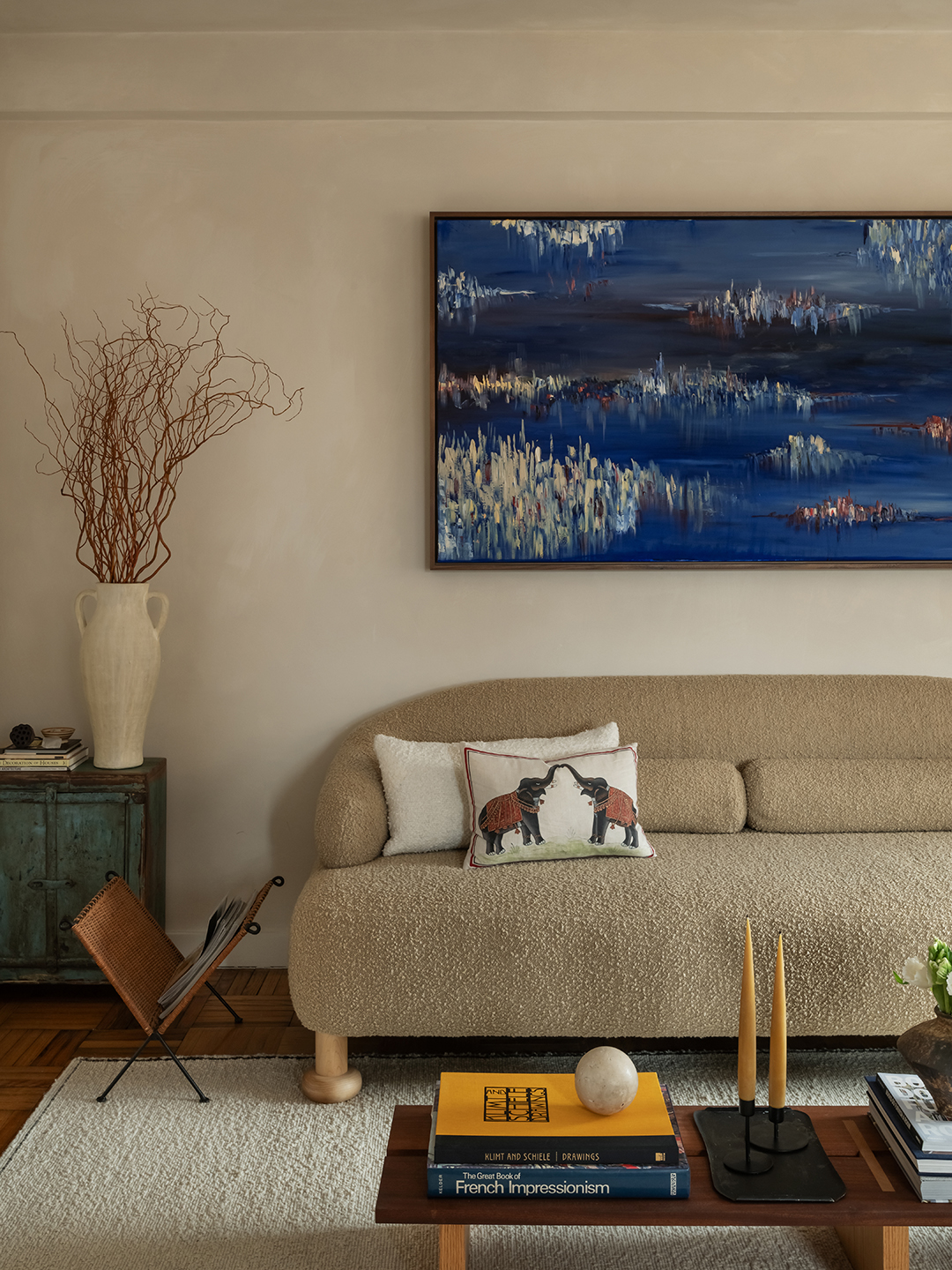 living room with artwork and beige sofa