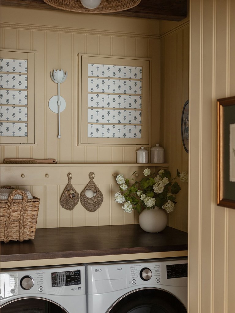 cream laundry room with hanging rail