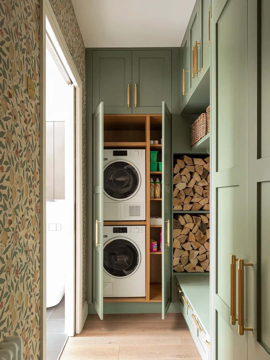 sage laundry room with stacked wood and wallpaper