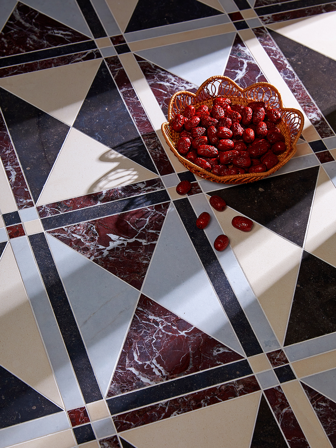 marble tiles with basket of red fruit on top