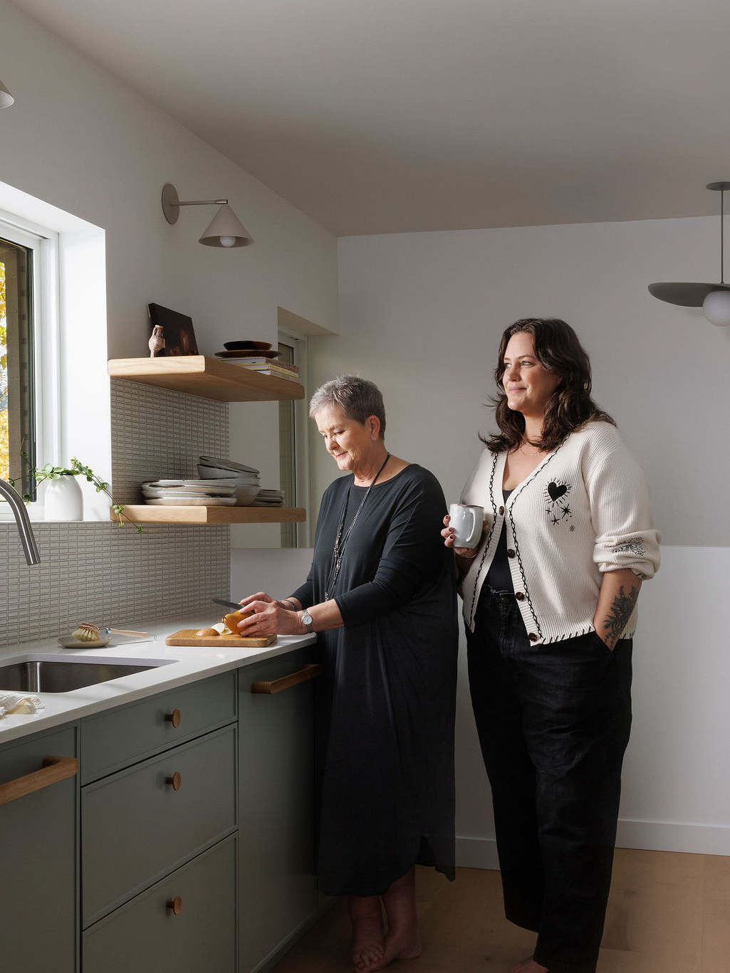 two women standing in kitchen