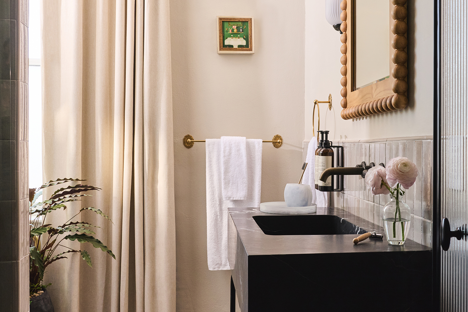 bathroom with marble sink and wood mirror