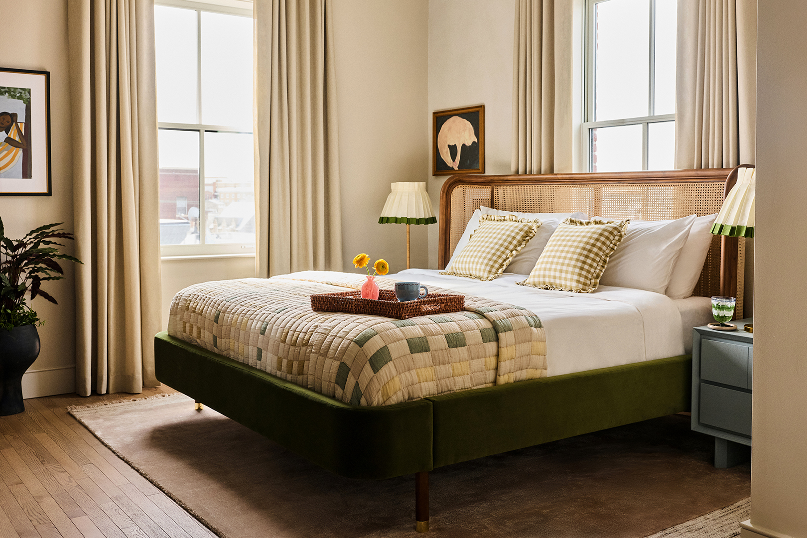 hotel suite bedroom with rattan headboard and quilt on bed