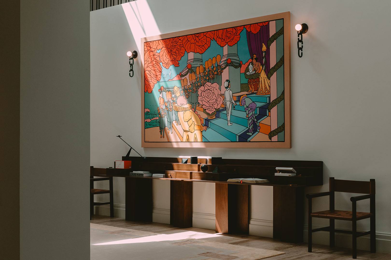 room with large artwork, two sconces, and long console