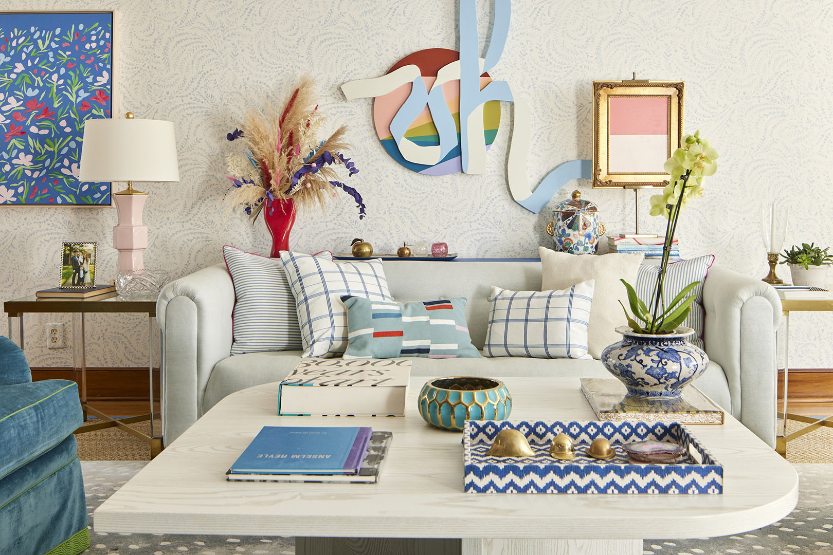 living room with white sofa, lots of pillows, and artwork on wall