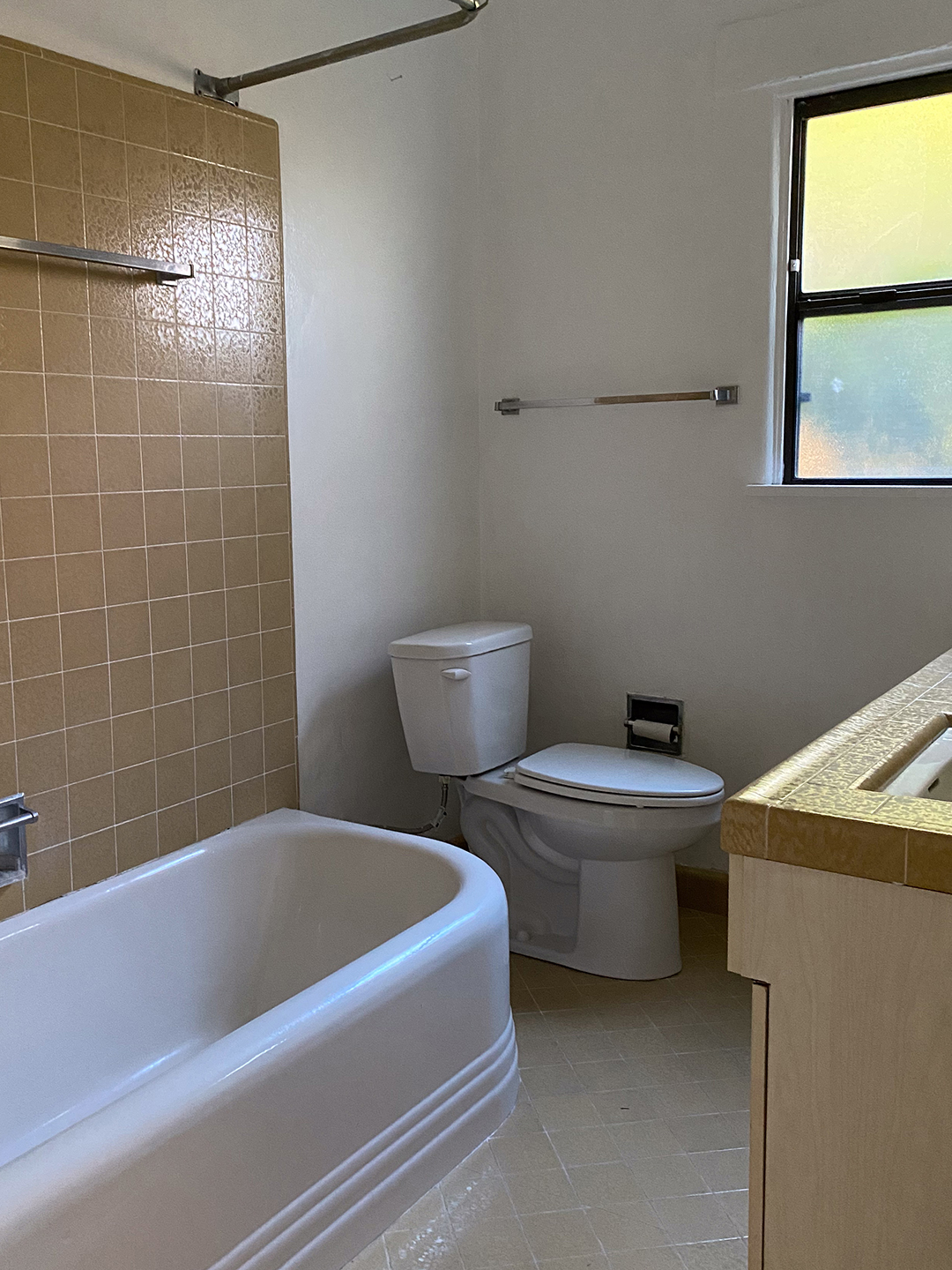 white bathroom with tan tiles