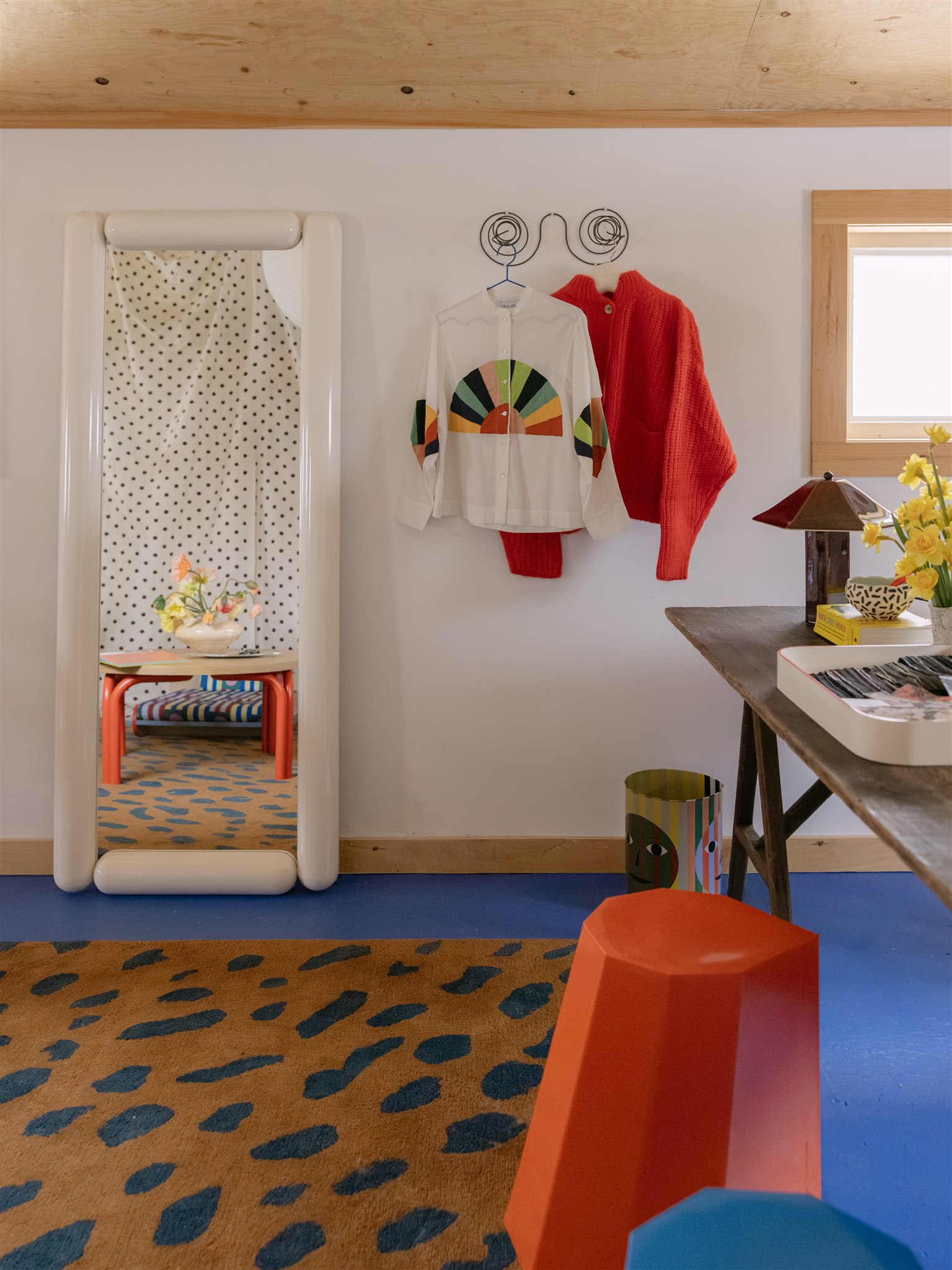 room with blue floor, leopard rug, white walls
