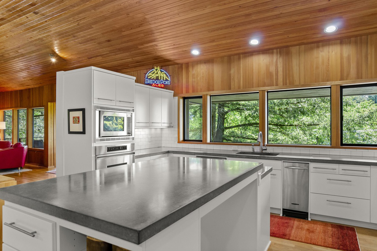 white kitchen with wood ceiling and floors