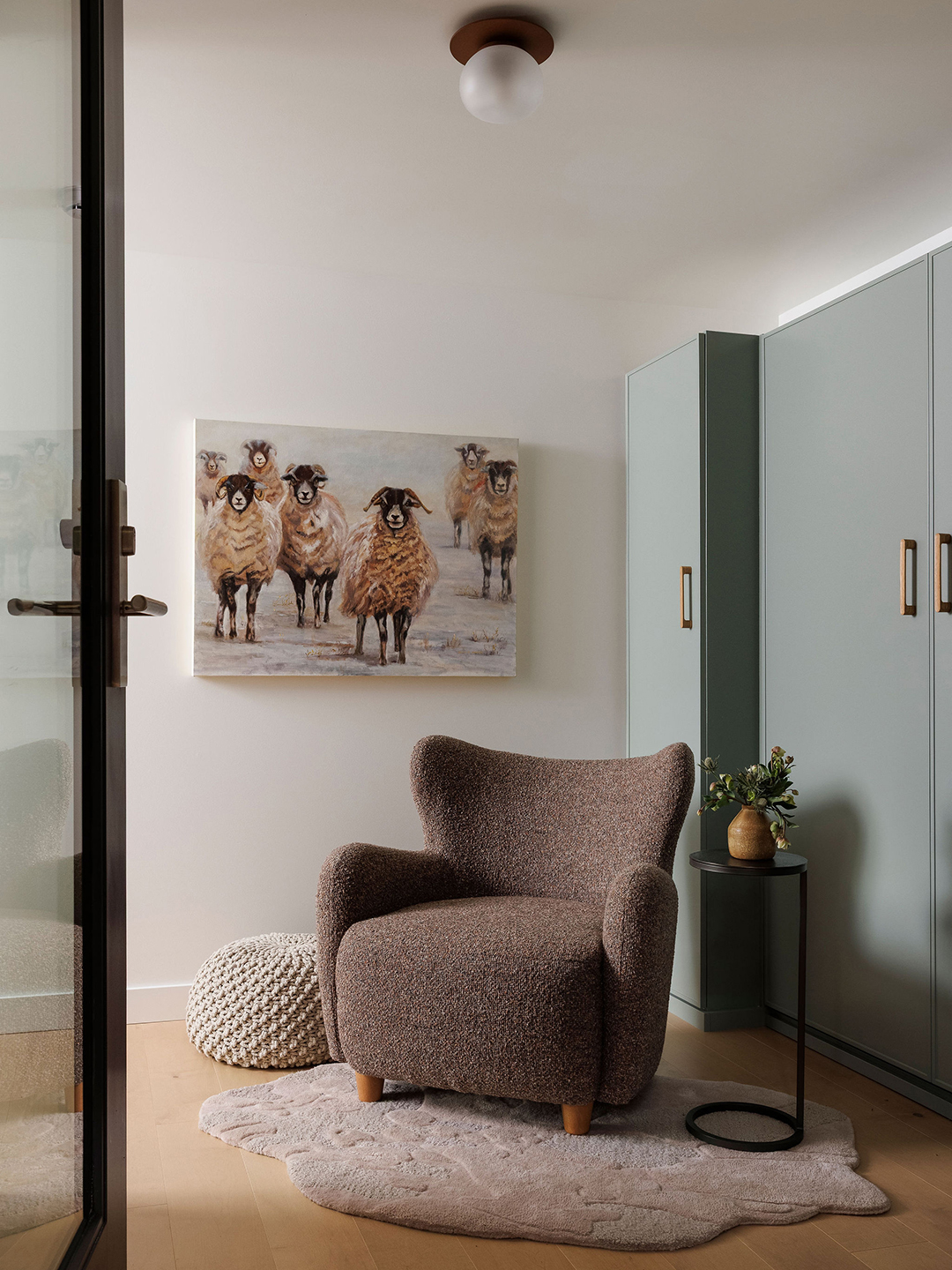 sitting area with brown chair and artwork