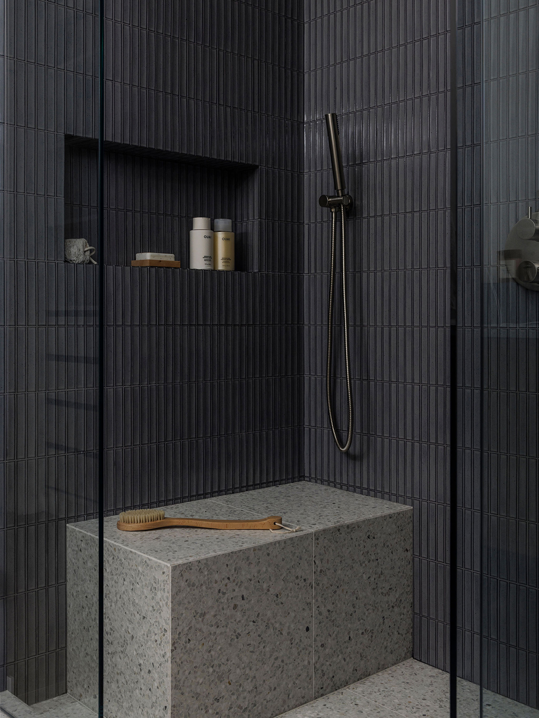 bathroom with bench and dark blue tiles