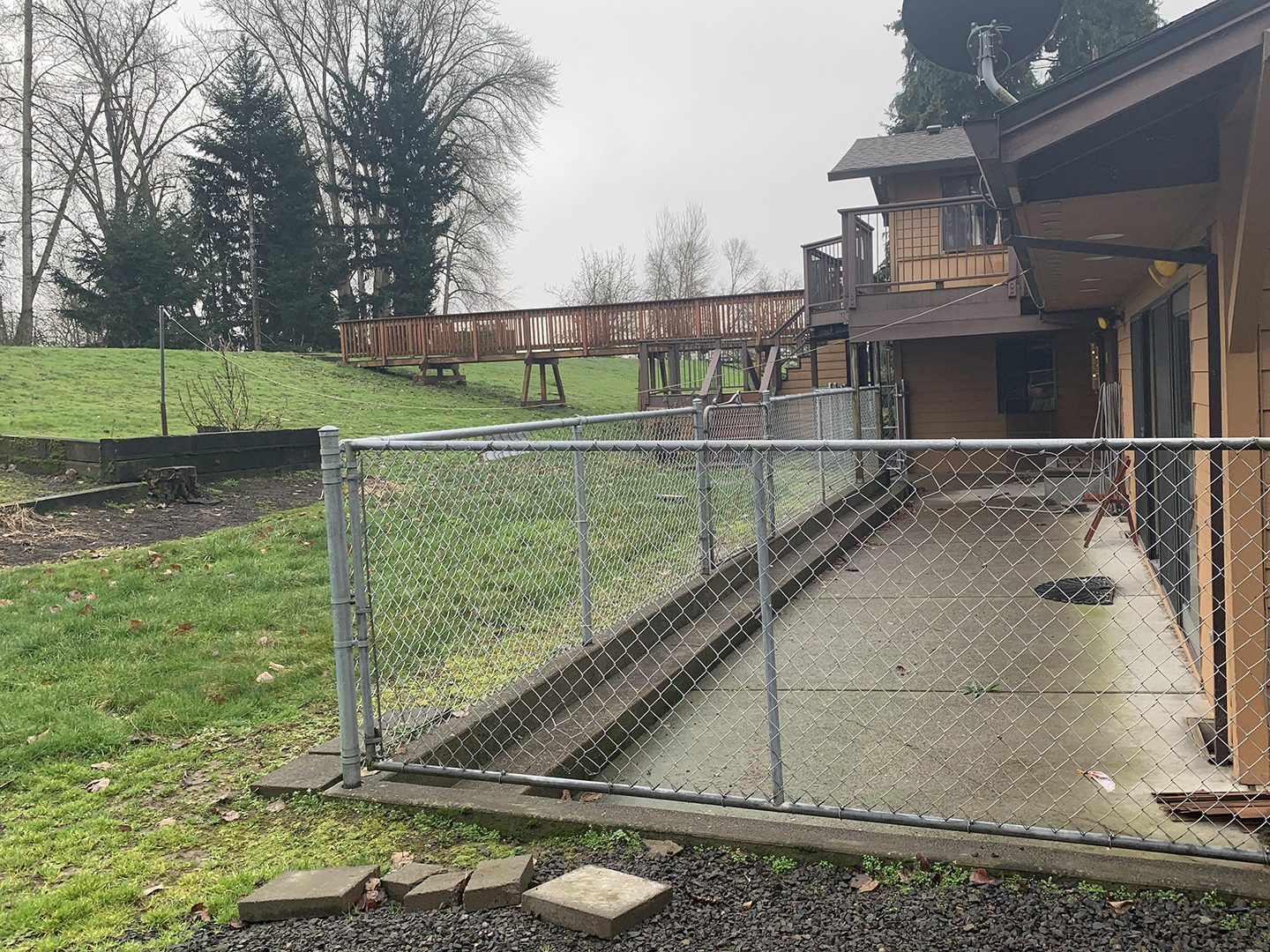 house with concrete slab and chain-link fence