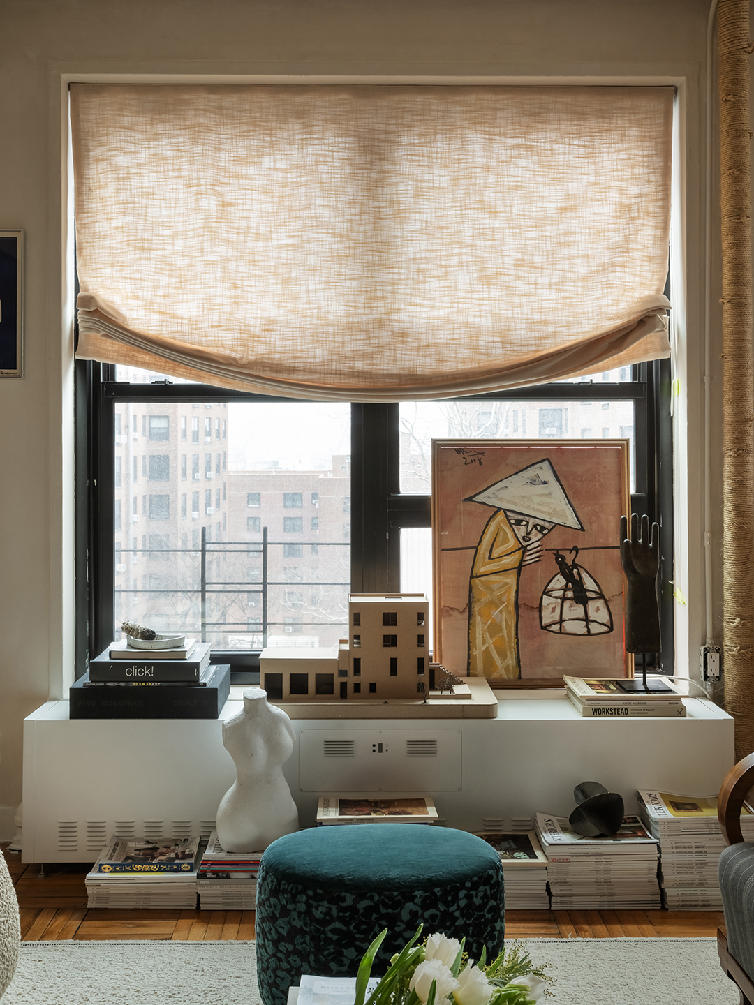 living room with art and fabric curtain