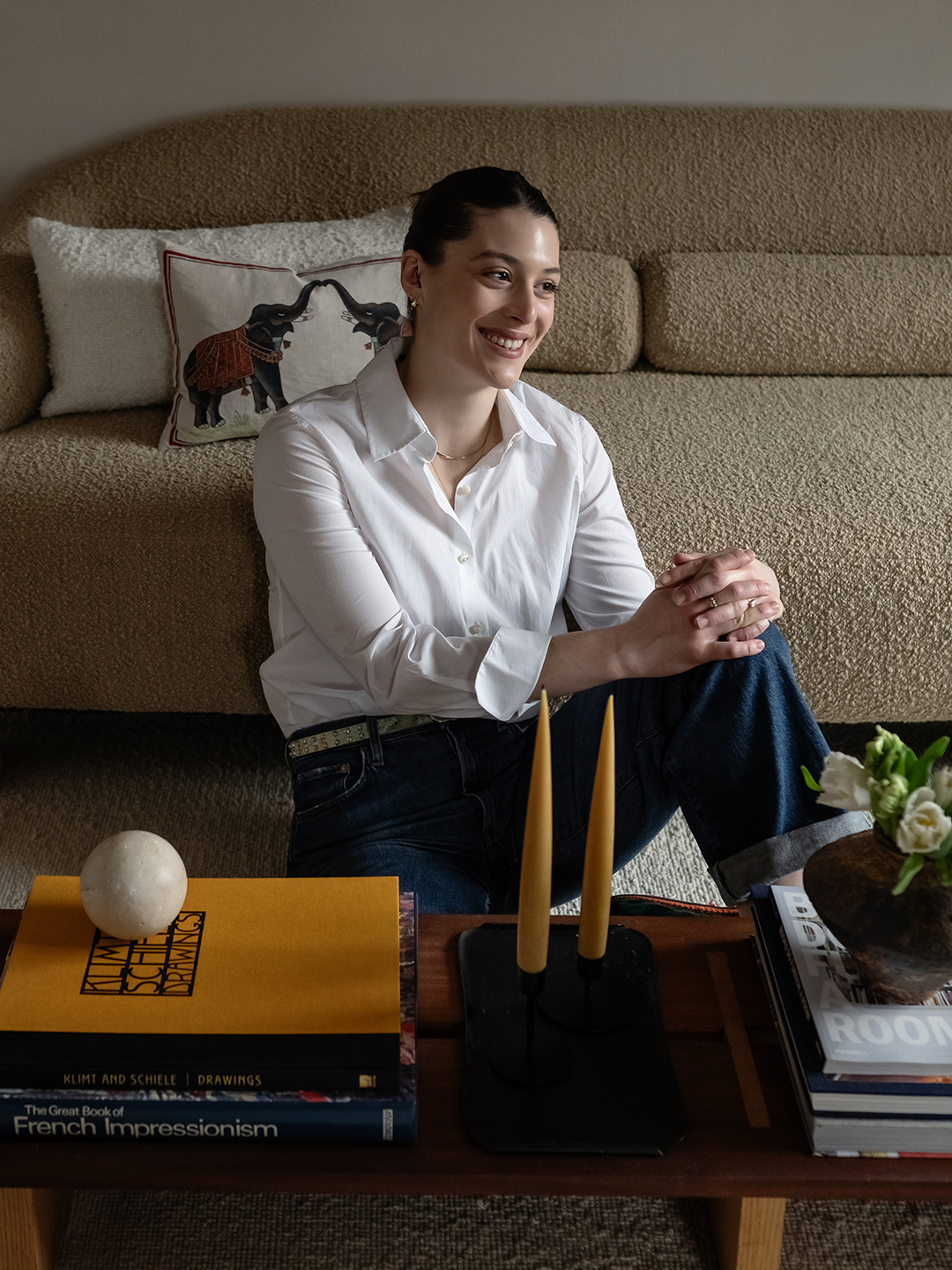 hannah hemmerly sitting in front of beige sofa