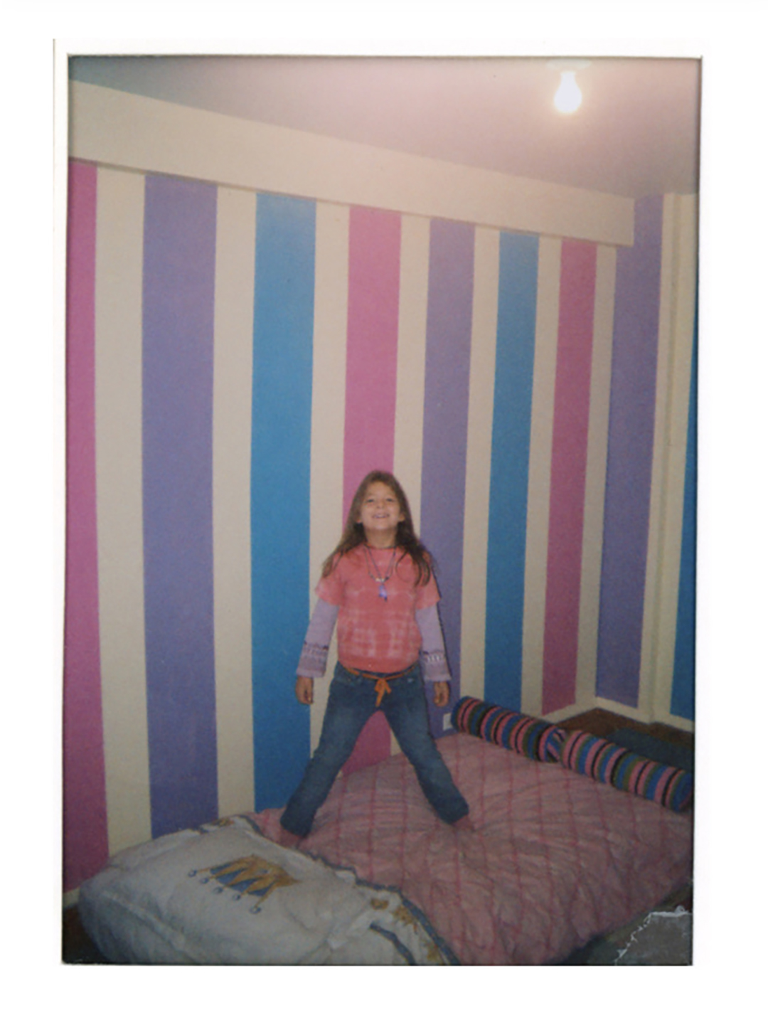 young girl in striped bedroom