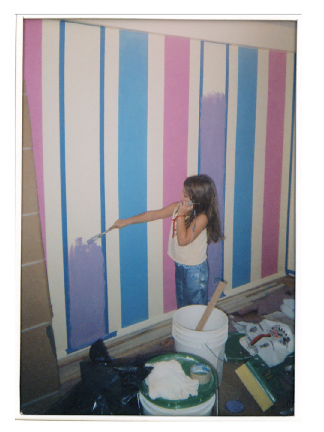 girl in bedroom painting stripes