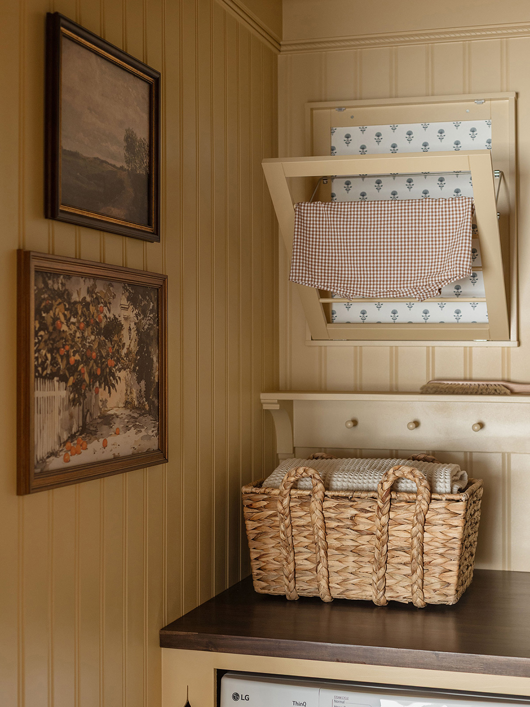 corner of a laundry room with art