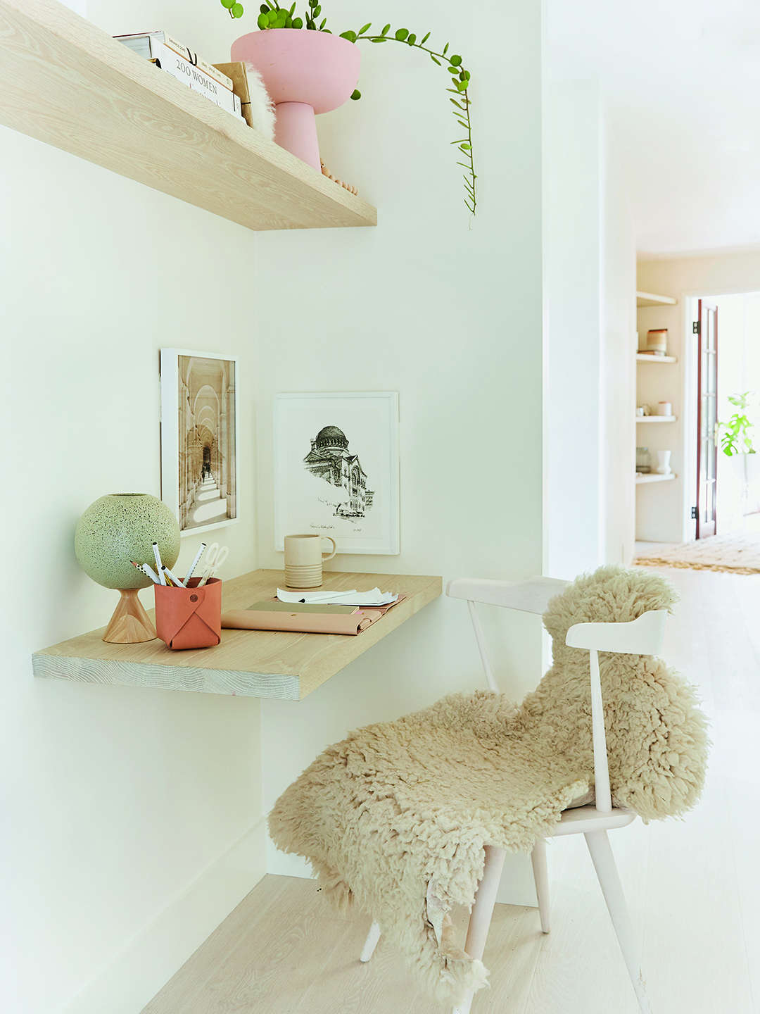 white room with floating shelf desk