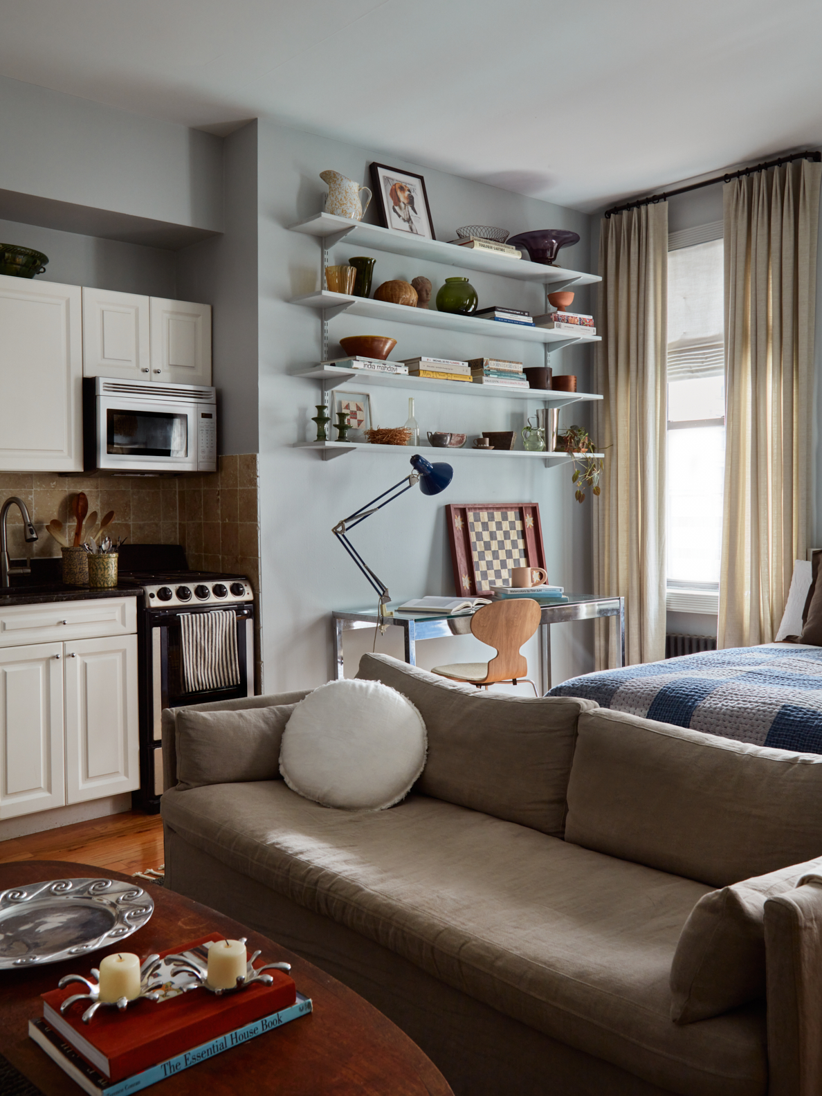 living room with beige sofa and desk area in corner