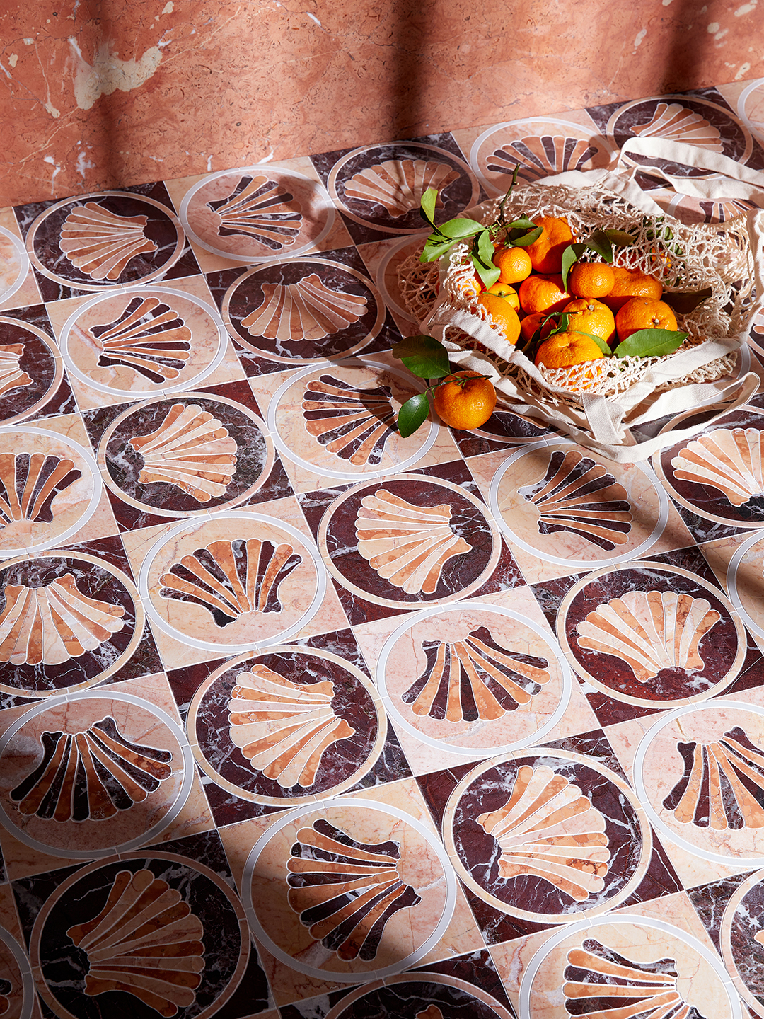 marble pattern tiles with shell motif and bag of oranges