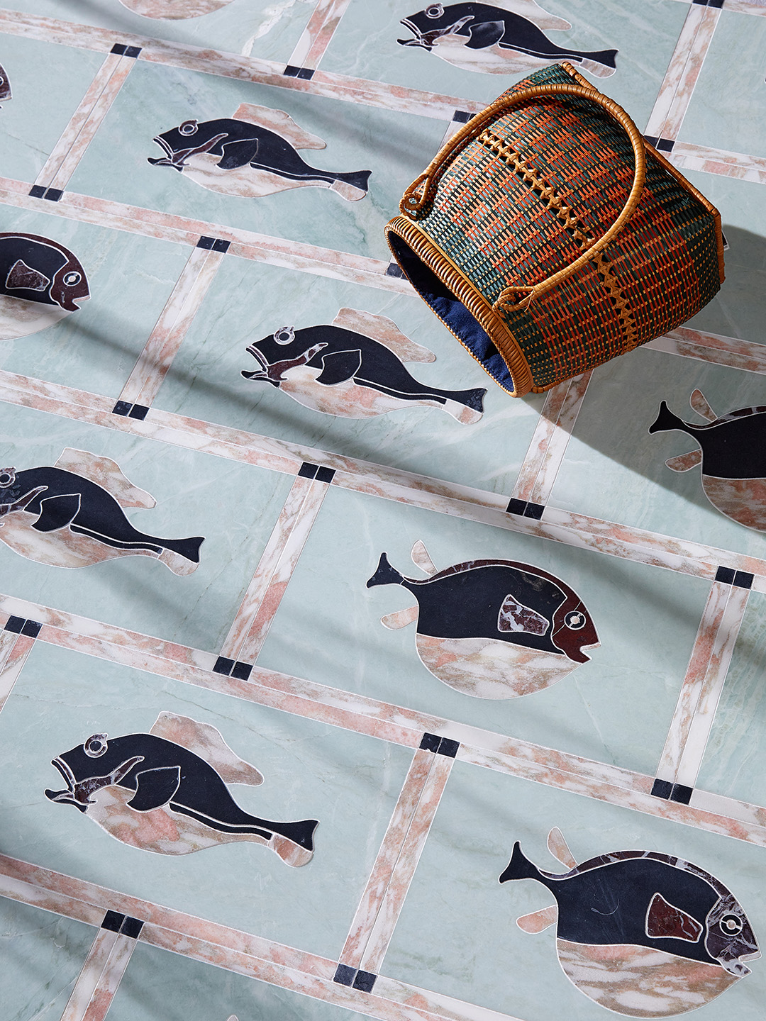 marble tile with fish motif and a basket