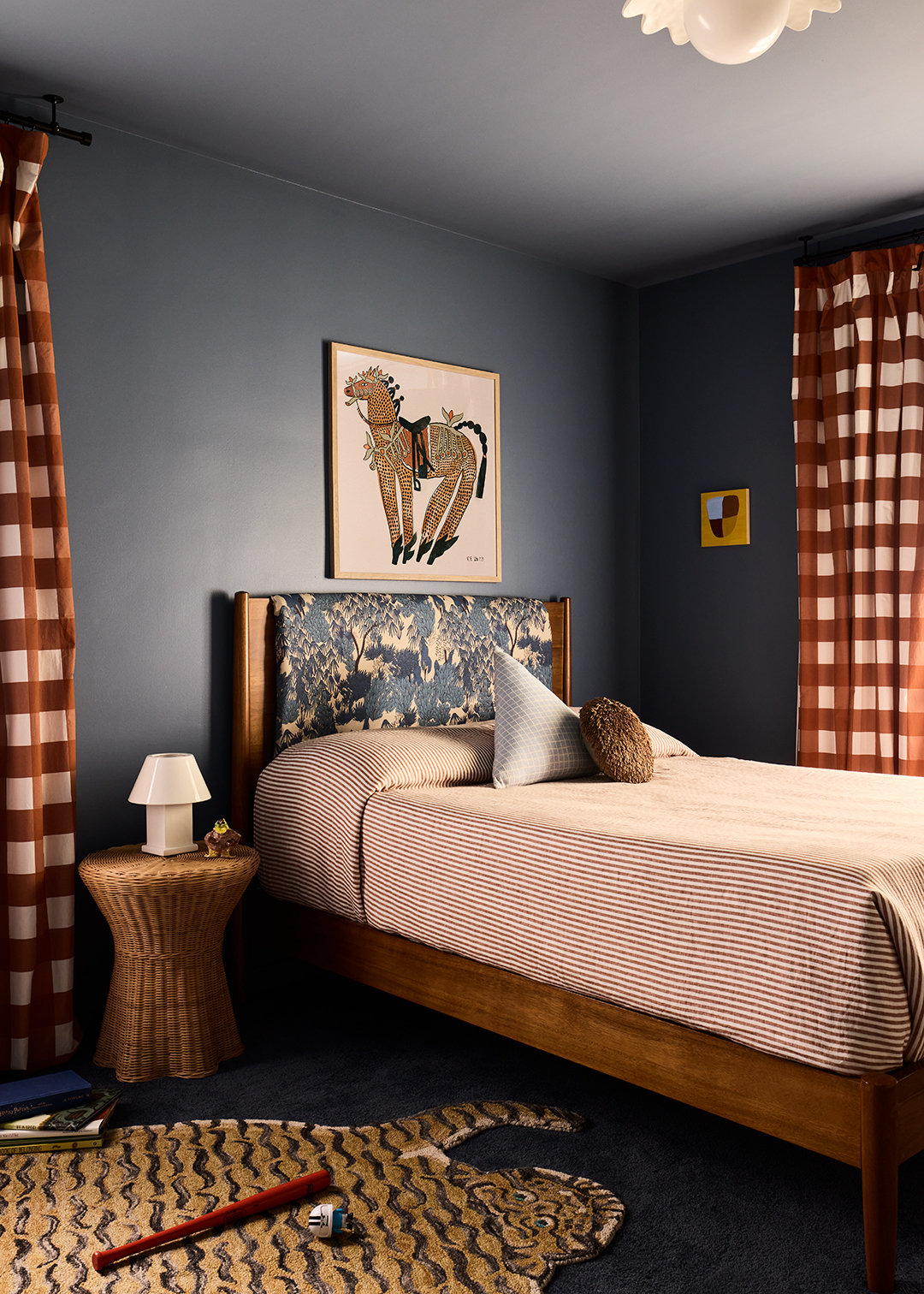 bedroom with tiger rug and oversized gingham curtains