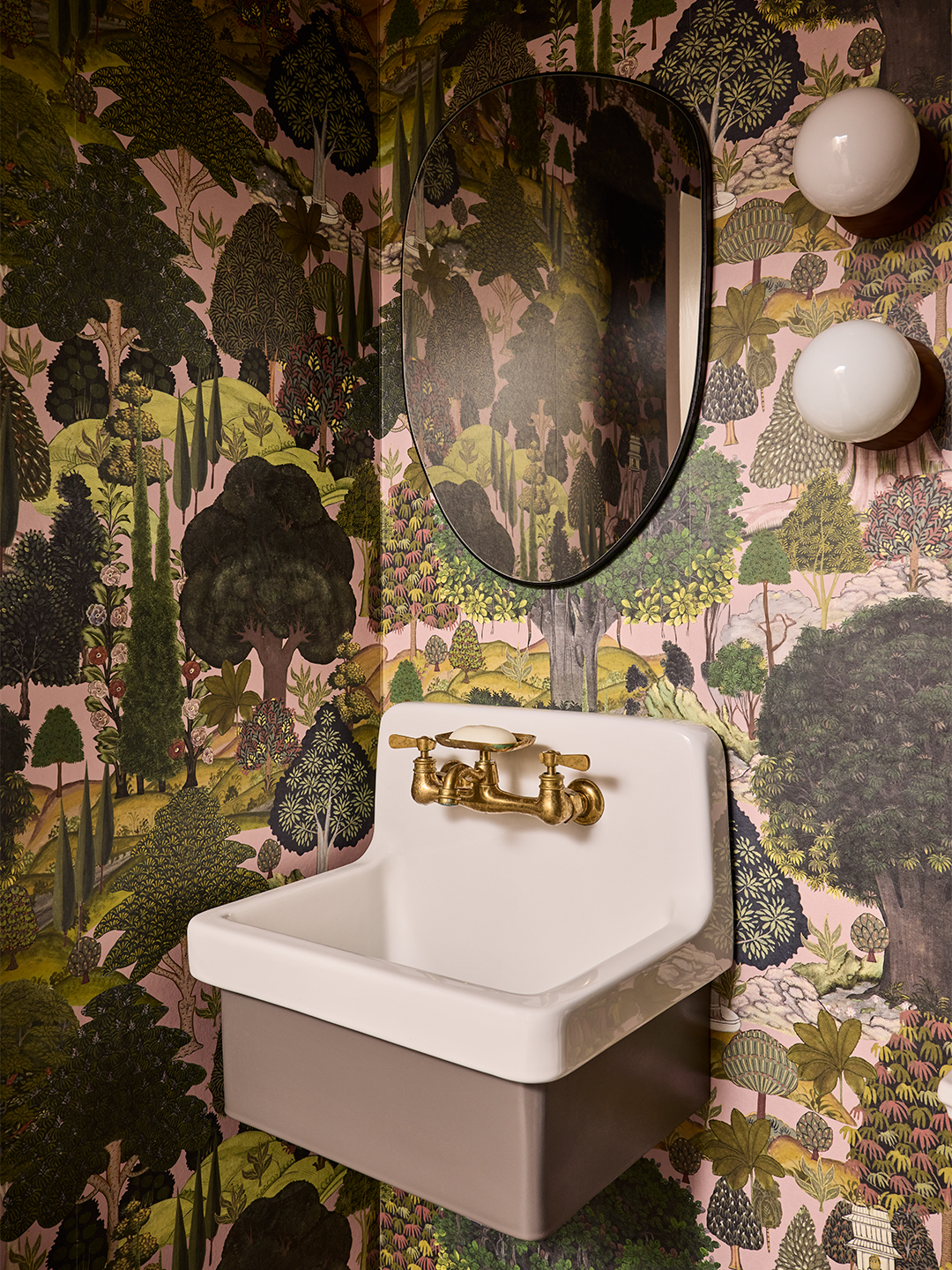 powder room with forest wallpaper and white sink