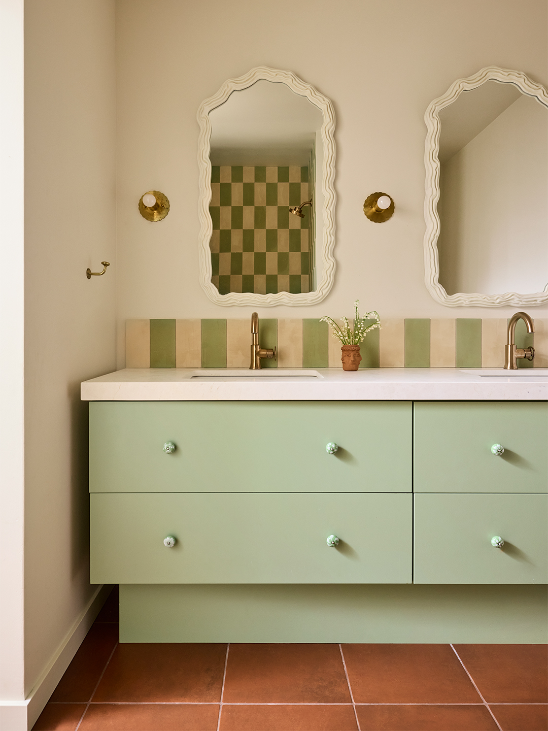 bathroom with soft teal cabinets and knobs