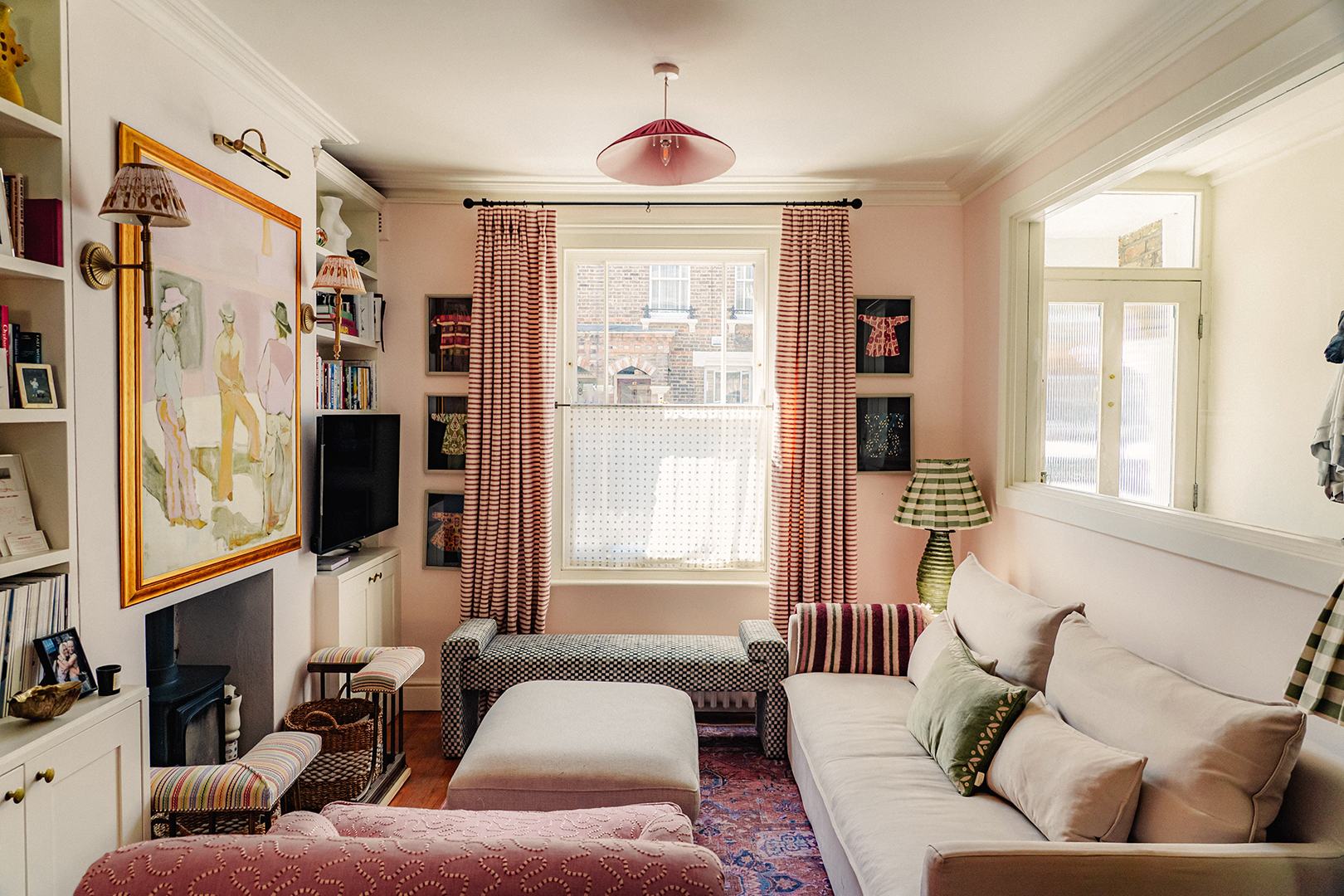 living room with pink wall and pink furniture