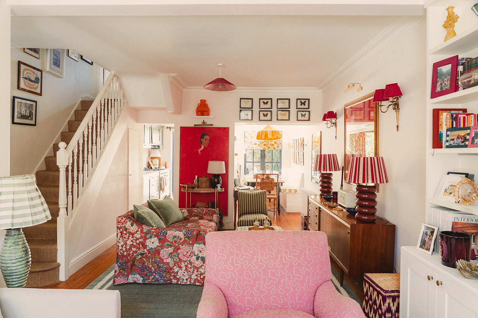 living room with colorful furniture and lots of art on walls