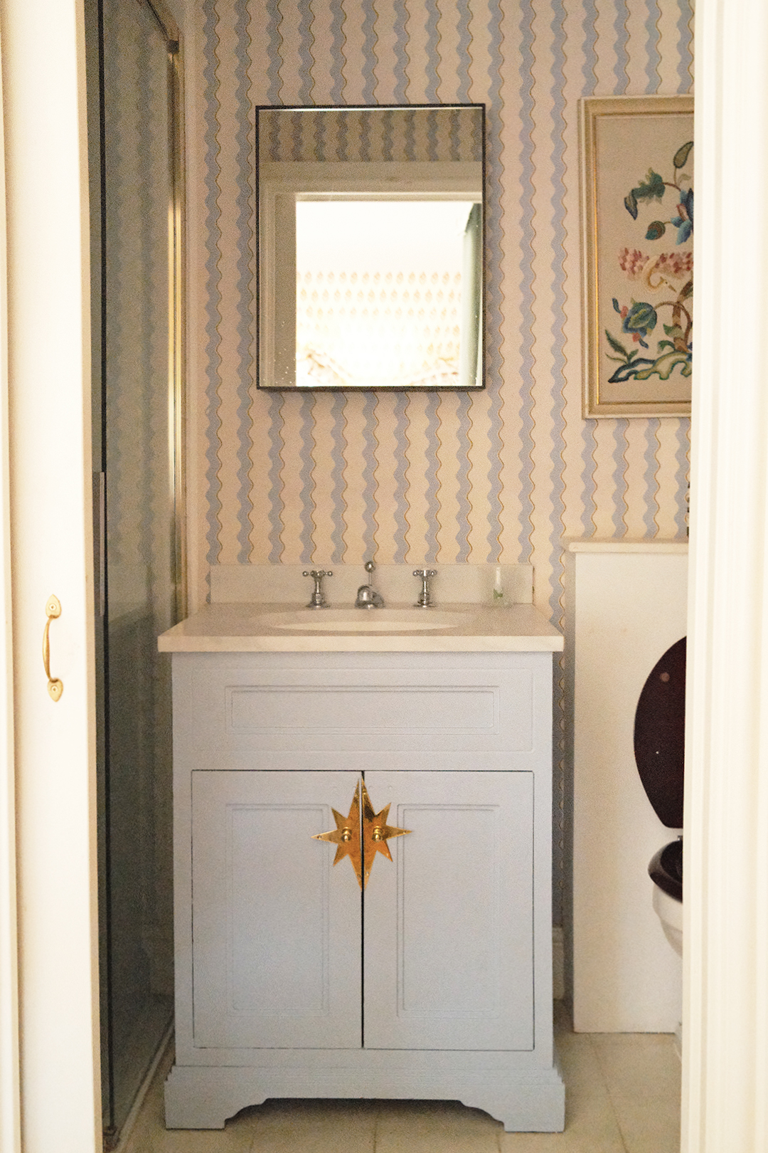 bathroom with sink and wiggly wallpaper