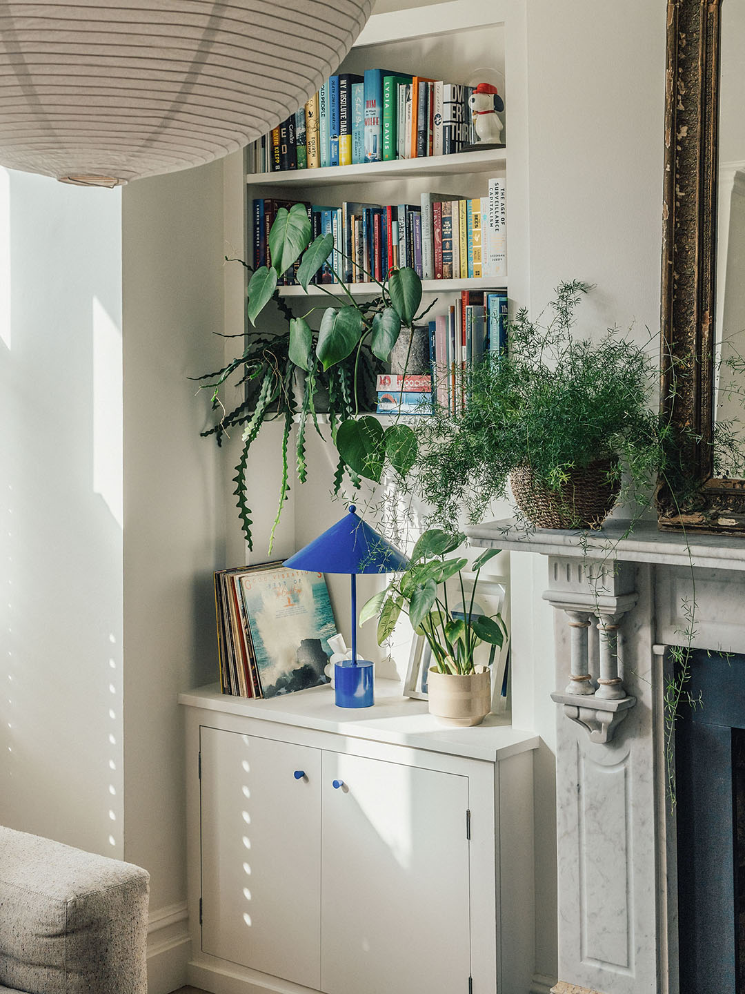 built-in bookcase beside a marble mantel