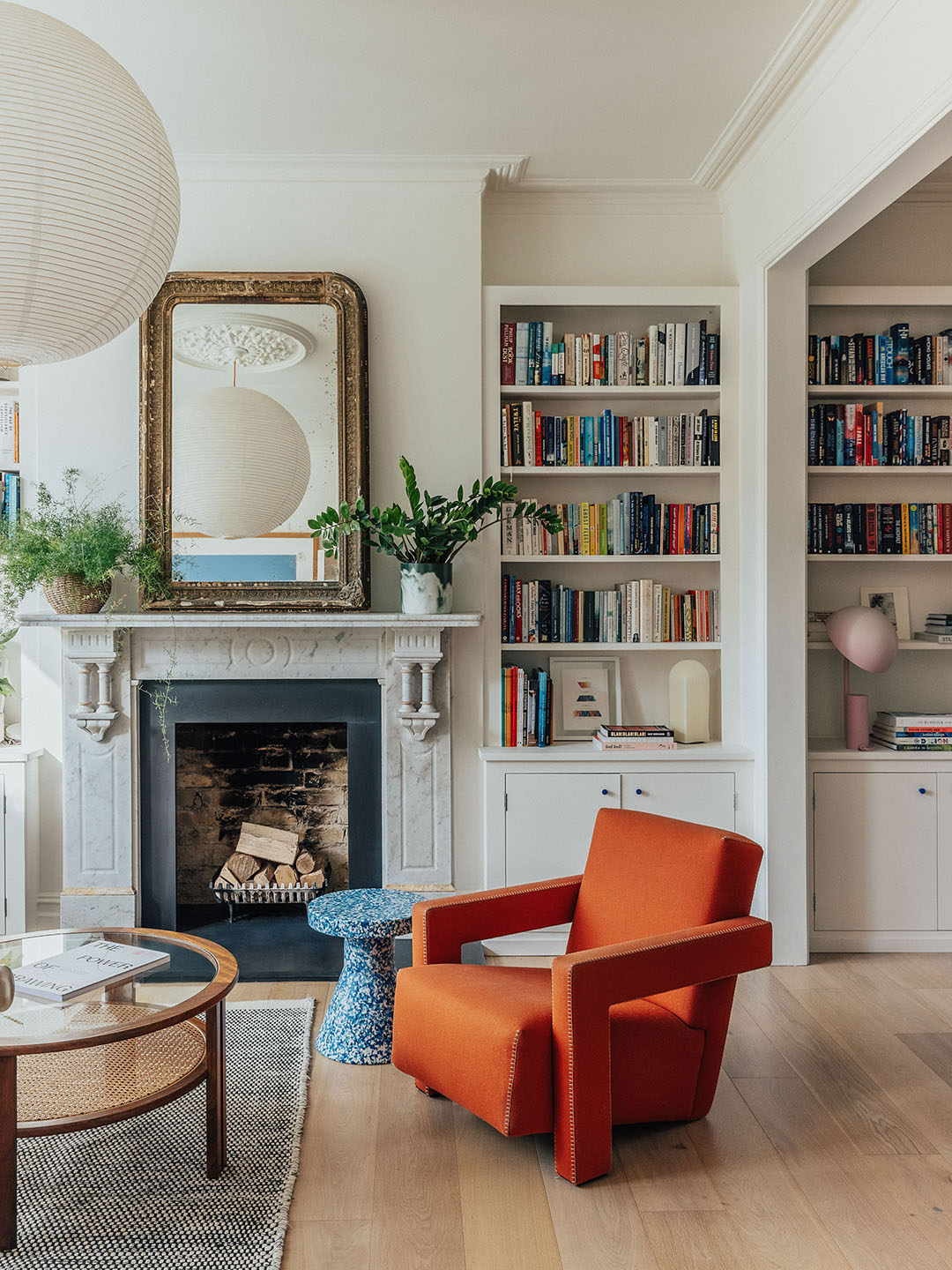 living room with built-in bookcases beside a fireplace