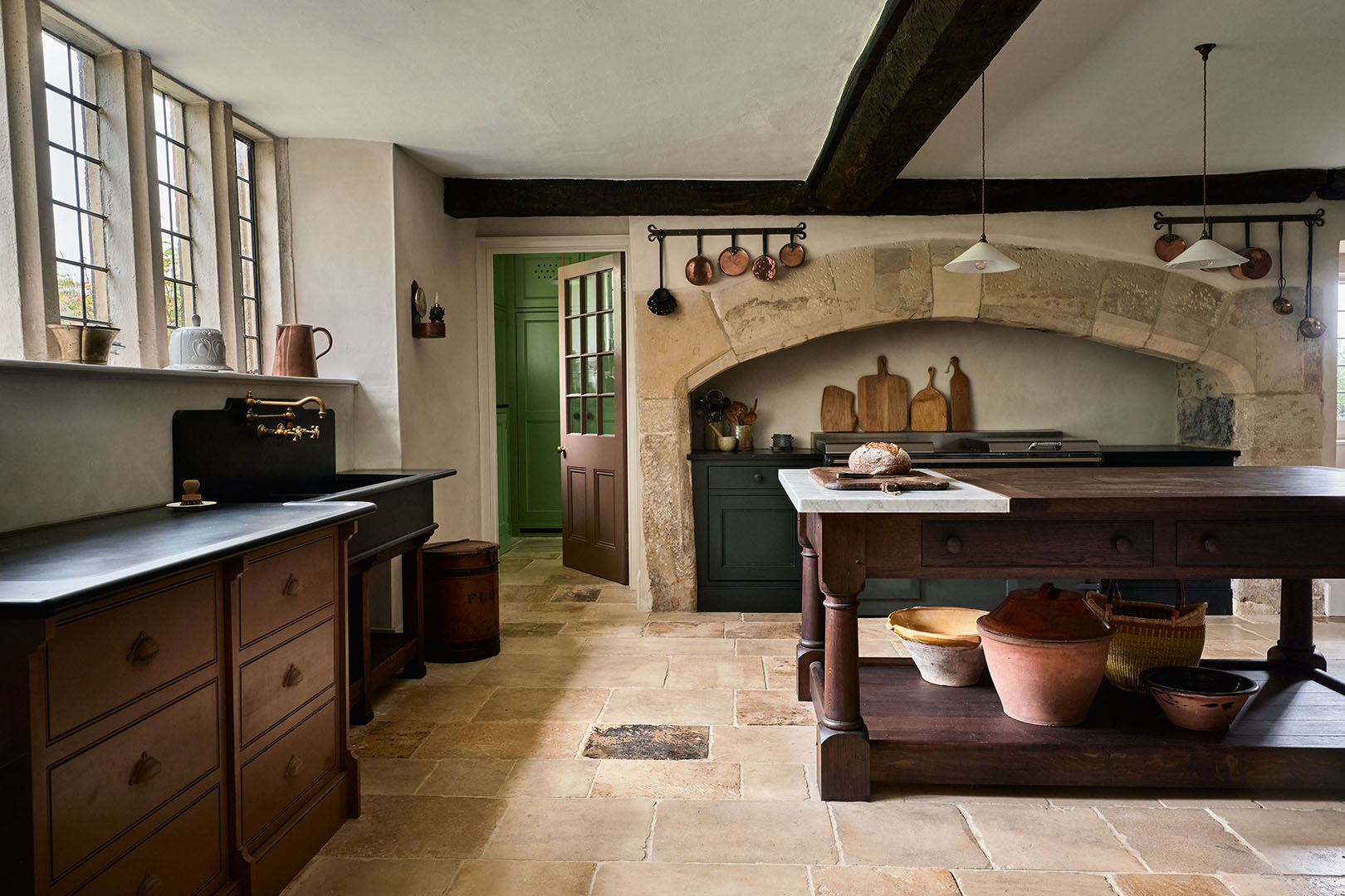 kitchen with stone floors and wood furniture