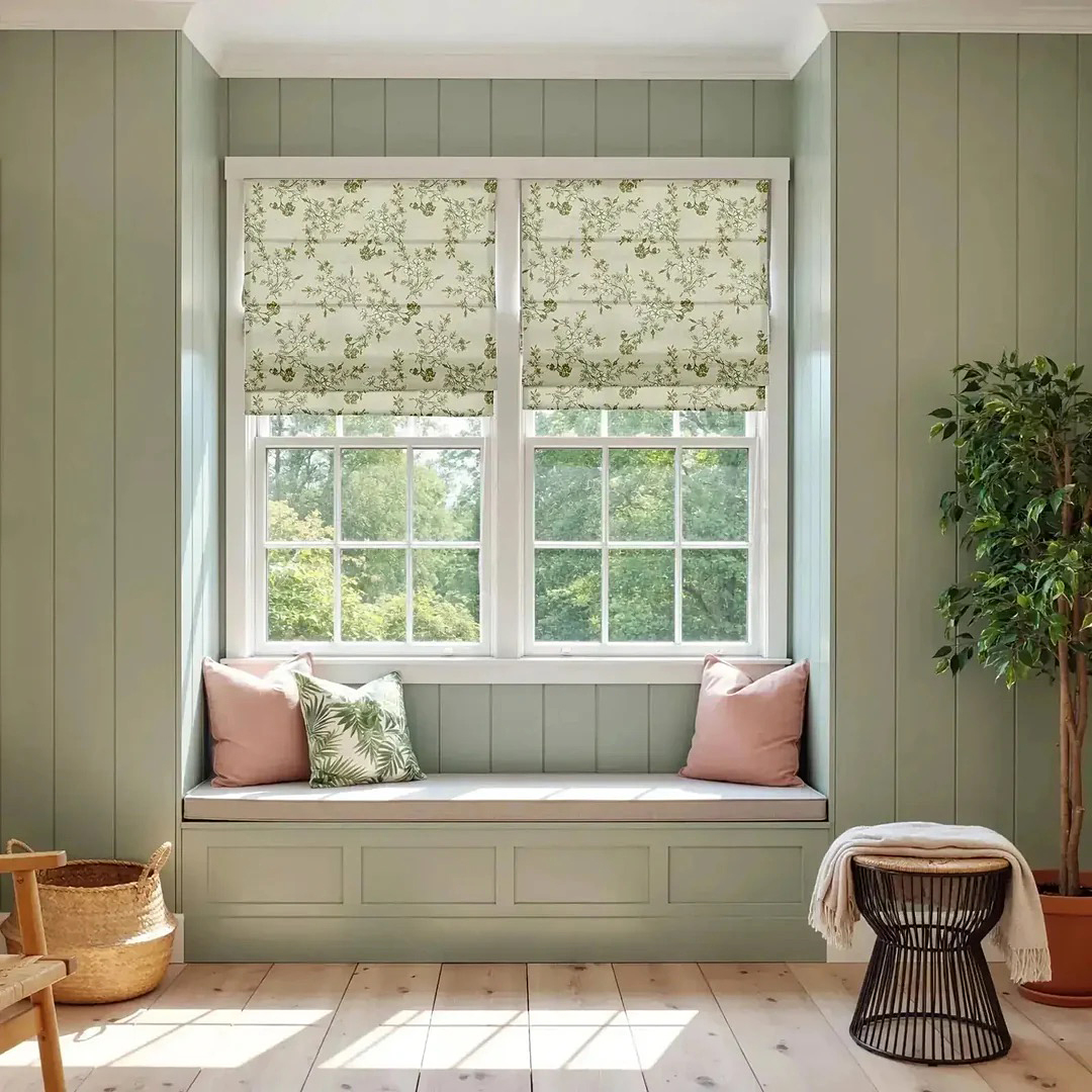Sage green room with window seat and floral Roman shades. 