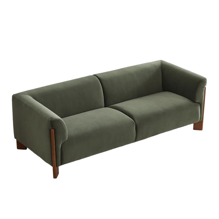 green sofa with exposed wood legs